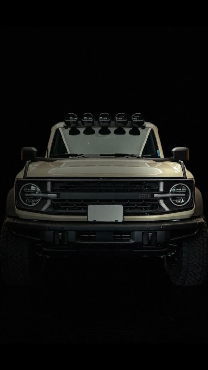 Play the sample car video: a tan truck with roof lights on a black background